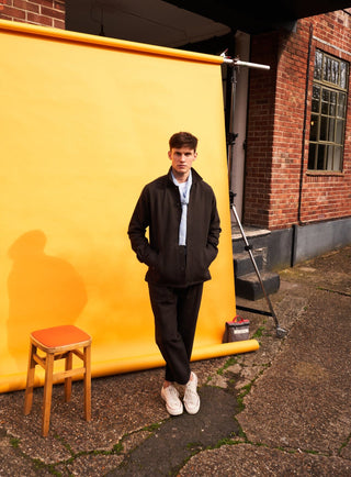 Chocolate Bomber Trousers/ Chinos tailored from a robust cotton twill with a button fastening.  They are a rich brown twill woven in Italy with 60% recycled cotton.